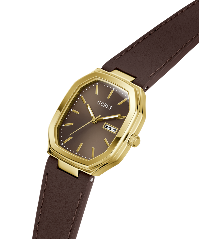A Guess wristwatch with an octagonal gold-tone case, a dark brown dial, and a matching brown leather strap, shown on a plain white background. lifestyle