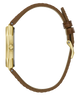 A side profile view of a watch with a gold-tone case and a brown leather strap, isolated on a white background.