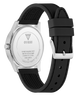 A close-up shot of a Guess watch showing the back of the silver stainless steel case and its black textured silicone strap, set against a plain white background.