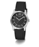 A GUESS men's analog watch featuring a black textured dial, silver-tone stainless steel case, and a black rubber strap, shown against a plain white background.