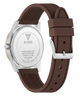 A close-up shot of a Guess watch showing the back of the silver stainless steel case and its black textured silicone strap, set against a plain white background.