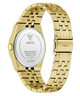 Gold-tone stainless steel watch shown from the back, featuring a matching metal link bracelet, a silver-toned circular case back with GUESS branding, and a GUESS logo engraved on the clasp.