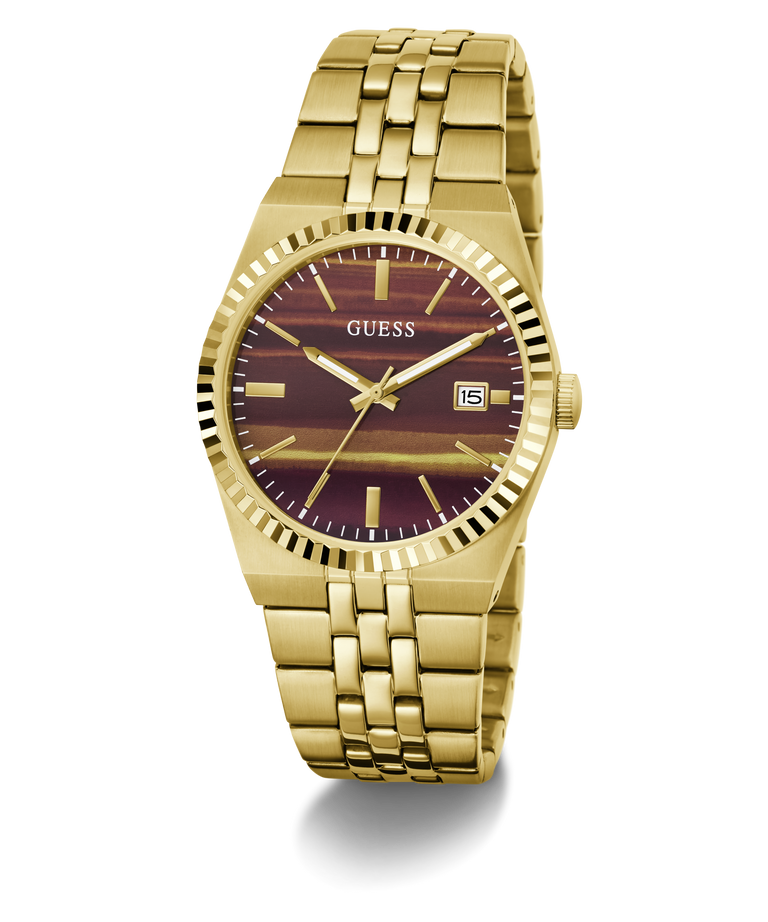 A gold-tone stainless steel wrist watch by Guess, featuring a fluted bezel, a gold-tone link bracelet, and a dark burgundy dial with gold-tone hour markers and hands.