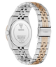 A close-up rear view of a GUESS wristwatch with a two-tone stainless steel and rose gold link band, showing the branded back cover and clasp on a white background.