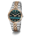 A Guess men's two-tone stainless steel and rose gold watch with a dark green tiger-stripe dial and a fluted bezel, shown on a white background with a soft shadow.