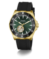 A GUESS Automatic watch with a gold-tone case, black textured strap, and a dark green dial featuring a skeletonized sub-dial showing the inner movement.