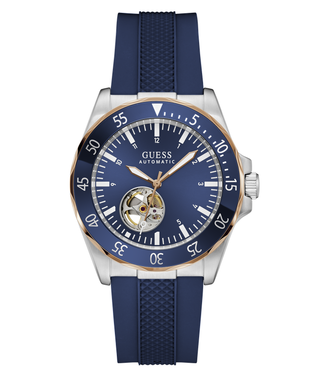 Guess Automatic watch with a blue dial, blue bezel, and blue textured strap, featuring a silver-tone stainless steel case with a gold-tone rotating bezel and a visible tourbillon movement.