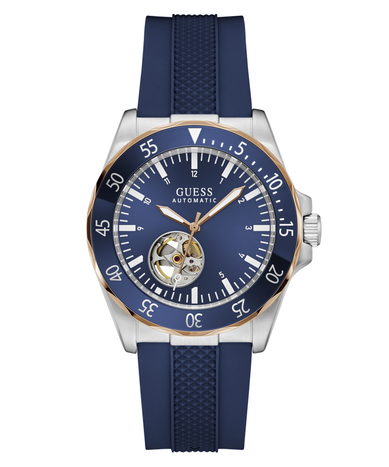 Guess Automatic watch with a blue dial, blue bezel, and blue textured strap, featuring a silver-tone stainless steel case with a gold-tone rotating bezel and a visible tourbillon movement.