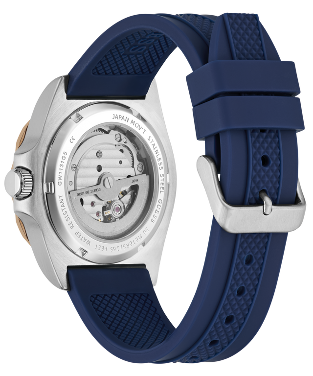 Ronda watch shown from the back, featuring a silver stainless steel case with a visible mechanical movement and a textured navy blue silicone strap with a silver buckle.