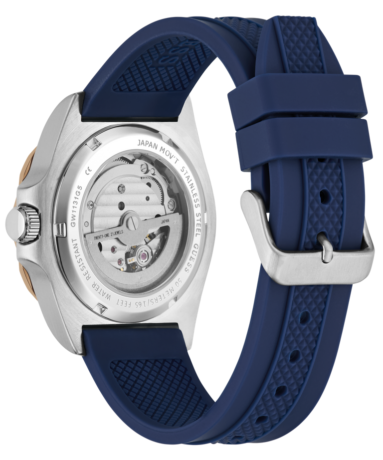 Ronda watch shown from the back, featuring a silver stainless steel case with a visible mechanical movement and a textured navy blue silicone strap with a silver buckle.