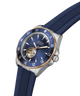 A Guess Automatic watch with a dark blue dial, a blue textured rubber strap, a stainless steel case, and a rose gold bezel. lifestyle