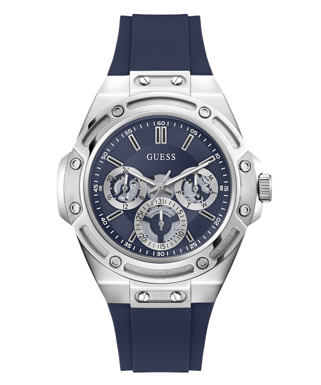 A Guess men's watch featuring a silver stainless steel case with a distinctive screw-decorated bezel, a dark blue dial with three sub-dials, and a dark blue silicone strap, shown against a plain white background.