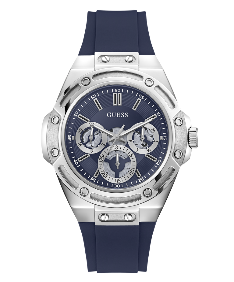 A Guess men's watch featuring a silver stainless steel case with a distinctive screw-decorated bezel, a dark blue dial with three sub-dials, and a dark blue silicone strap, shown against a plain white background.