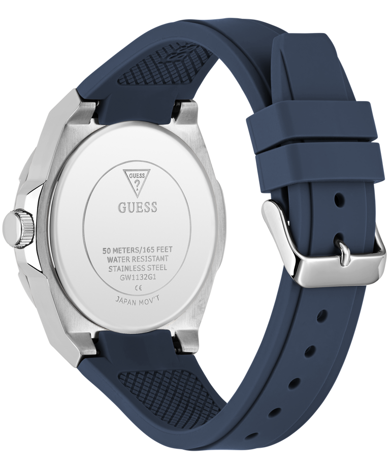 The back view of a Guess watch with a silver stainless steel case and a dark navy blue silicone strap, shown on a solid white background.