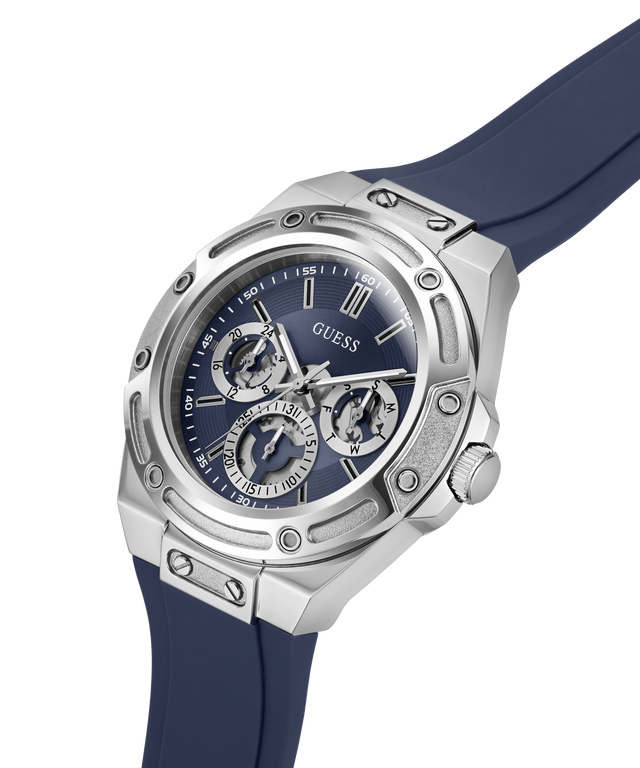A Guess men's watch featuring a silver stainless steel case, a blue dial with three sub-dials, and a dark blue silicone strap, shown on a clean white background. lifestyle