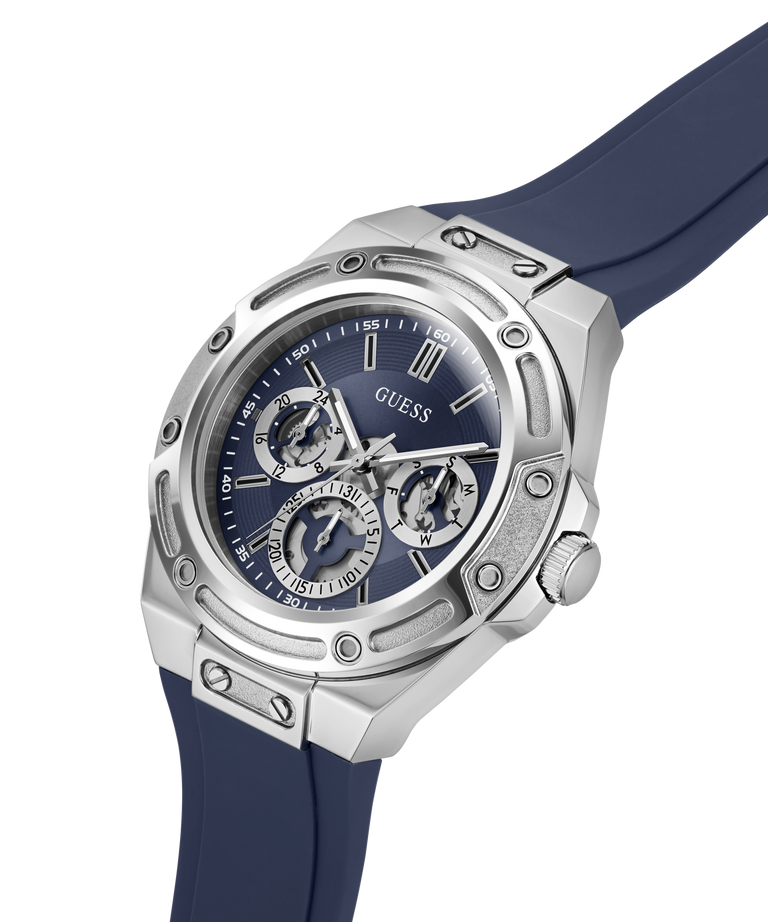 A Guess men's watch featuring a silver stainless steel case, a blue dial with three sub-dials, and a dark blue silicone strap, shown on a clean white background. lifestyle