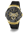 A GUESS men's chronograph watch featuring a black case, black dial, and black rubber strap, accented with gold-tone bezel, lugs, hands, indices, and crown.
