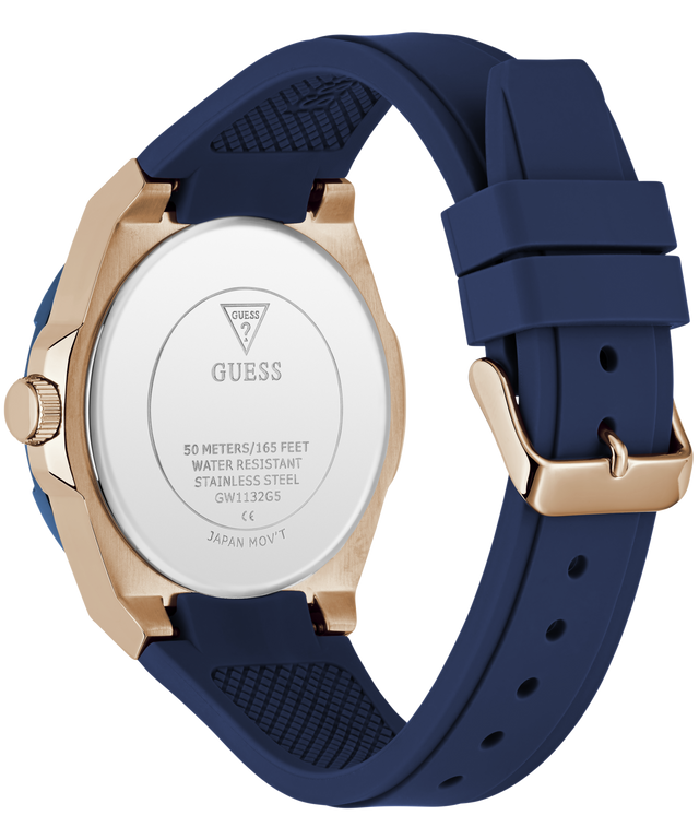 A close-up rear view of a Guess watch with a navy blue silicone strap and a rose gold case, showing the brushed stainless steel back case.