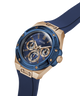 A Guess wristwatch with a blue dial, blue bezel, rose gold case, and blue strap, shown on a clean white background. lifestyle