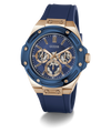 A GUESS men's chronograph watch featuring a blue bezel and blue silicone strap, paired with a rose gold-tone case and a blue dial with gold-tone subdials.