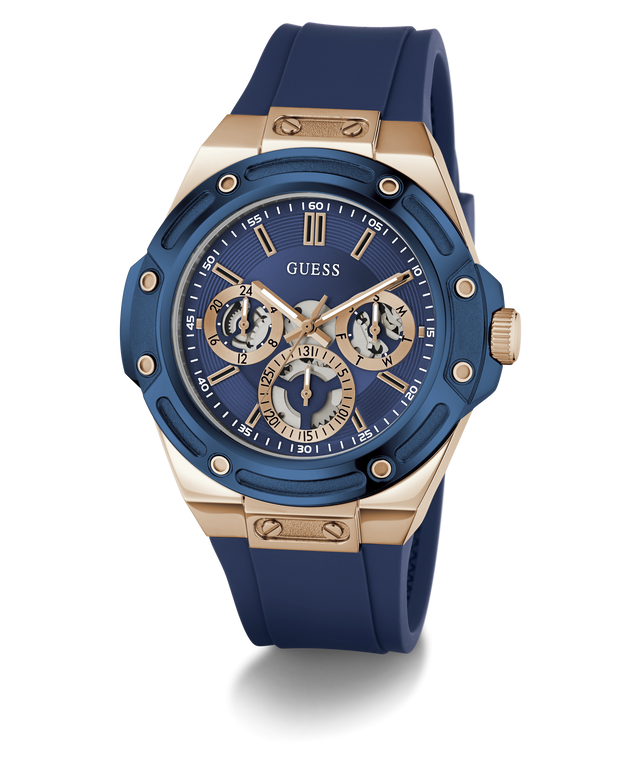 A GUESS men's chronograph watch featuring a blue bezel and blue silicone strap, paired with a rose gold-tone case and a blue dial with gold-tone subdials.