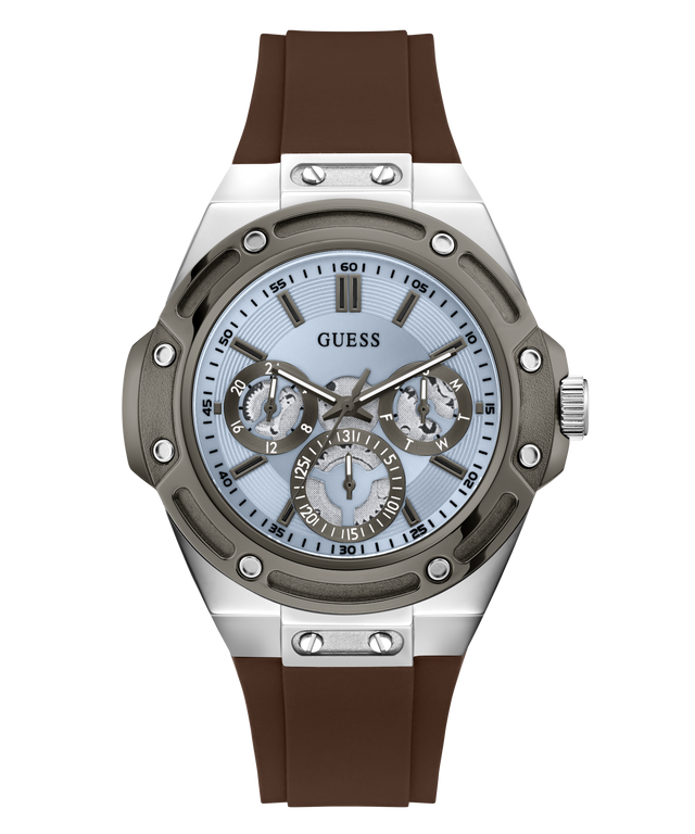 A Guess men's watch featuring a silver stainless steel case, a light blue dial with three sub-dials, and a brown silicone strap, shown against a plain white background.