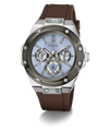 A GUESS men's watch featuring a brown silicone strap, a silver-toned stainless steel case, and a light blue dial with chronograph sub-dials.