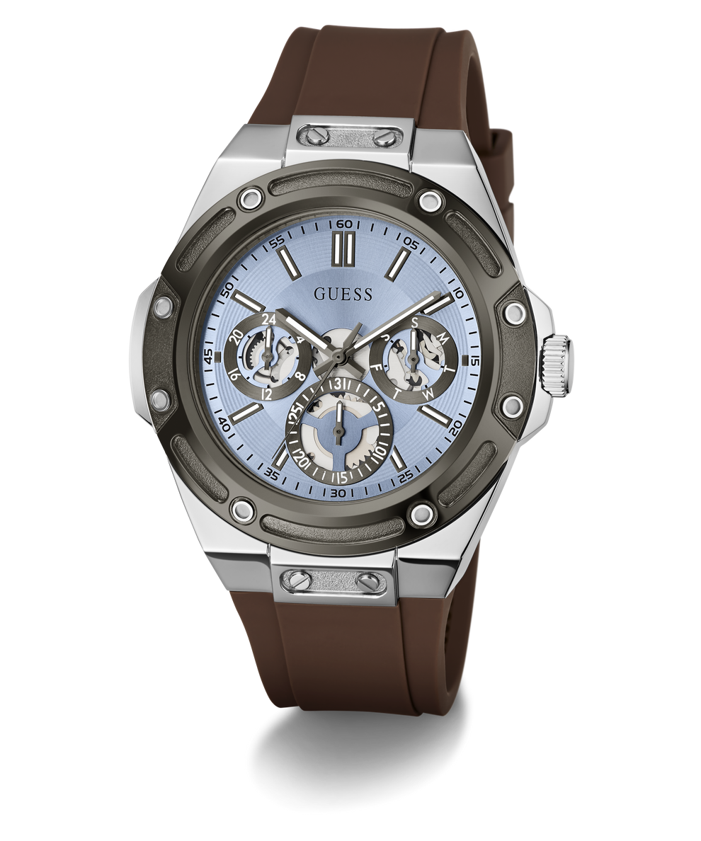 A GUESS men's watch featuring a brown silicone strap, a silver-toned stainless steel case, and a light blue dial with chronograph sub-dials.