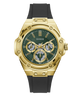 A gold-tone Guess wristwatch with a dark green dial, gold subdials, and a black silicone strap, shown against a plain white background.