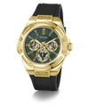 A GUESS men's watch featuring a gold-tone case, a dark green dial with three subdials, and a black silicone strap, shown on a clean white background.