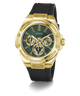 A GUESS men's watch featuring a gold-tone case, a dark green dial with three subdials, and a black silicone strap, shown on a clean white background.