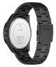 Black stainless steel watch shown from the back, featuring a black metal link bracelet, black case, and a silver-toned circular back cover with GUESS branding and technical specifications.