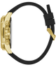 A close-up side view of a wristwatch with a gold-tone case, three-button chronograph layout, and a black rubber strap with a gold buckle, shown on a plain white background.