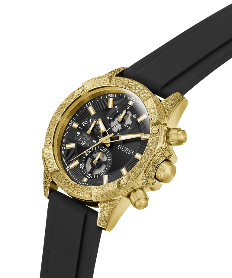 A Guess men's chronograph watch featuring a textured gold-tone case, a black dial with gold-tone subdials and markers, and a black rubber strap, shown on a white background. lifestyle