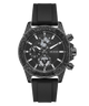 A GUESS chronograph watch with a textured dark gray and black case, a black dial with white markings, and a black silicone strap, shown against a plain white background.
