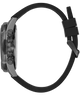 A close-up side view of a watch with a textured dark gray case, a black rubber strap, and a black magnetic clasp, shown against a plain white background.