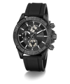 A GUESS chronograph watch with a textured dark gray and black case, a black dial with white markings, and a black rubber strap, shown on a white background with a soft shadow.