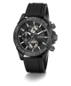 A GUESS chronograph watch with a textured dark gray and black case, a black dial with white markings, and a black rubber strap, shown on a white background with a soft shadow.