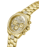 Gold-tone Guess wristwatch with a crystal-studded bezel, matching crystal-detailed dial, and a gold-tone link bracelet on a white background. lifestyle