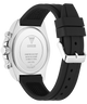 The back view of a GUESS watch with a silver stainless steel case and a black silicone strap, shown on a white background.