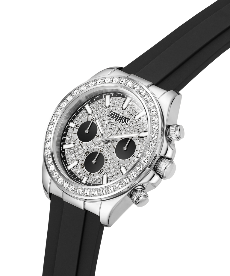 A Guess wristwatch with a silver-tone case, crystal-encrusted bezel, textured silver dial with three black subdials, and a black rubber strap, shown on a white background. lifestyle