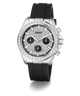 A Guess wristwatch with a silver-tone case, a bezel set with clear stones, a textured black dial with three black subdials, and a black silicone strap, shown on a white background.