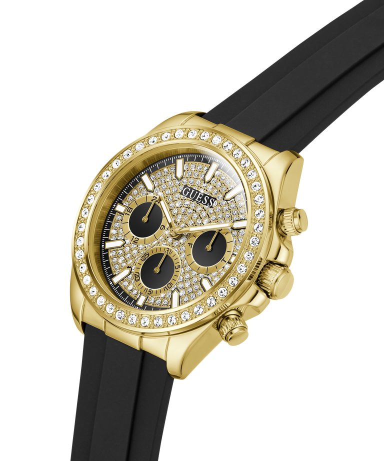 A gold-tone Guess chronograph watch with a diamond-encrusted bezel, black dial with gold details, and a black rubber strap, shown on a white background. lifestyle