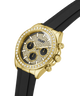A gold-tone Guess chronograph watch with a diamond-encrusted bezel, black dial with gold details, and a black rubber strap, shown on a white background. lifestyle