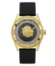 A luxury wristwatch by Guess featuring a gold-tone case with a central lion head motif, a textured gray dial, diamond accents, and a black strap, shown against a plain white background.