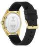 Back view of a GUESS watch with a gold-tone case and a black silicone strap, on a clean white background.