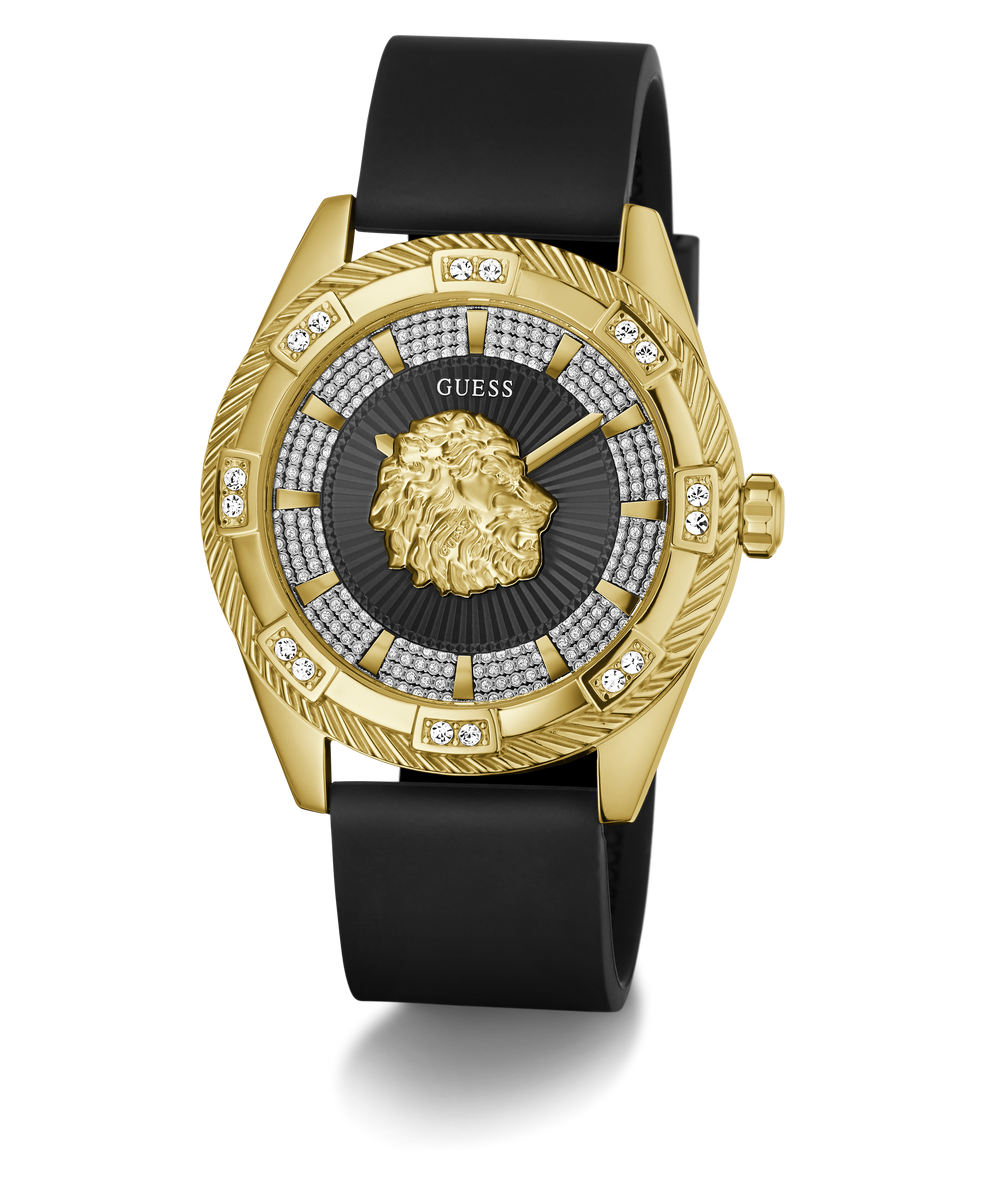 A luxury wristwatch by GUESS featuring a gold-tone case with a lion head dial, a black leather strap, and a bezel accented with diamonds.