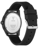 Black GUESS watch with a matte black silicone strap and a black case, showing the brushed silver-toned metal watch back with GUESS branding.