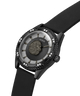 A luxury wristwatch by Guess featuring a black rubber strap, a textured black bezel adorned with small clear crystals, and a unique sunburst dial with a central lion head medallion. lifestyle