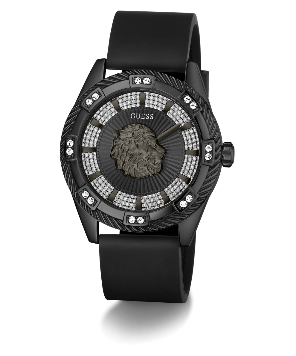 A luxury Guess wristwatch featuring a black rubber strap, a black case, and a highly detailed black dial with a central lion head motif, surrounded by rows of sparkling clear crystals.